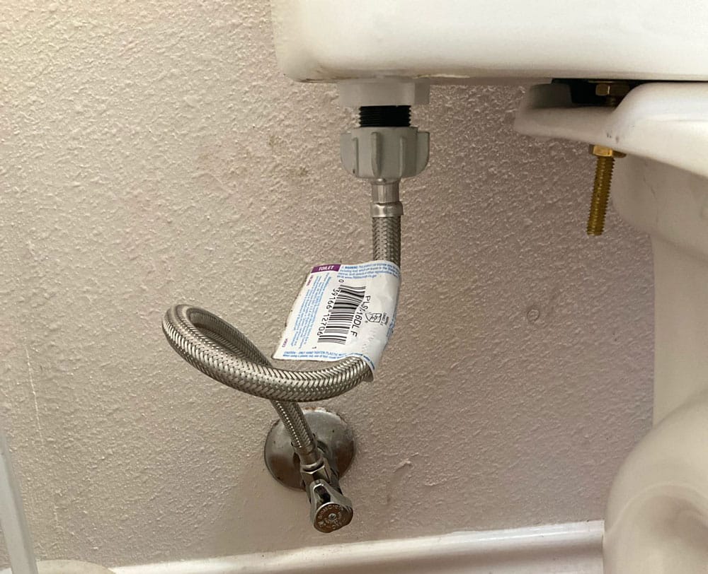 Toilet water supply line with a kinked flexible hose